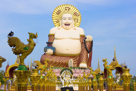 Wat Plai Laem Temple in Koh Samui, Thailand. Smiling big Buddha statue. Buddhism religion architecture building, iconic landmark, tourism attraction, sightseeing tour concept