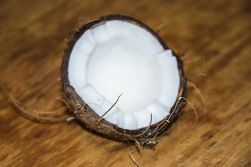 Cracked coconut on a wooden background
