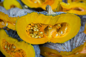 A Half of the green pumpkin show seed inside on local fresh market blur background.Thailand