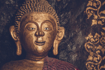 Golden buddha statue imagery in Buddhist temple indoor.Nan province Thailand copy space for text layout