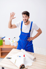 Worker working on wallpaper during refurbishment