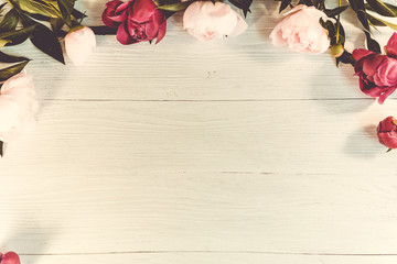 Summer floral frame with pink peonies with warm vintage toning
