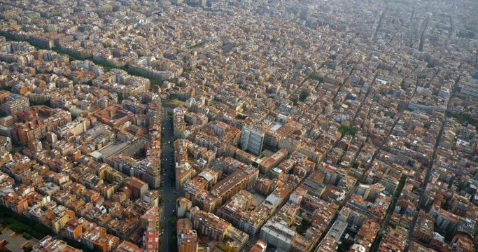 Aerial above Barcelona city buildings and streets, Spain