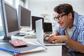 Businessman sitting in front of many screens