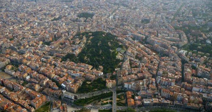 Flying above city of Barcelona buildings and streets, Spain