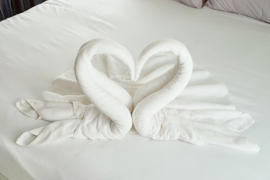 White Swan Or Heart Shape Blanket Origami Decoration On The Bed