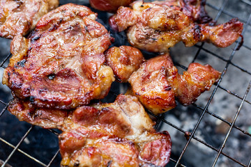 Grilled meat and steak on a grilled with smoke.