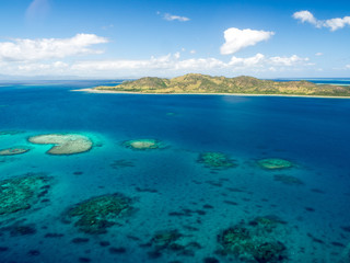 Aerial Landscape View of Tropical South Pacific Island Surrounded by White Sand Beach, Ocean and Reef in Fiji