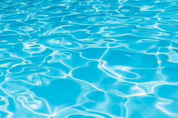 Abstract of blue water surface in swimming pool, Ripple wave in pool with sun reflections