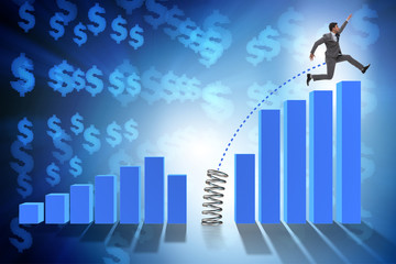 Business people jumping over bar charts