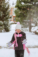 Little girl playing with snow