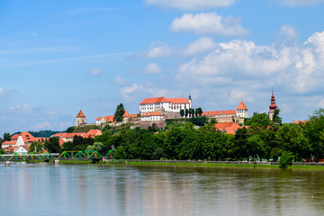 Naklejka na ściany i meble Ptuj, Slovenia, panoramic shot of oldest city in Slovenia with a castle overlooking the old town from a hill, clouds time lapse