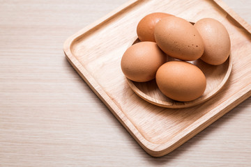 Close-up view of chicken eggs on wooden table background