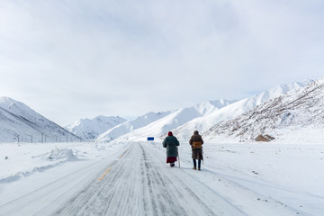 two pilgrims on snow area plateau