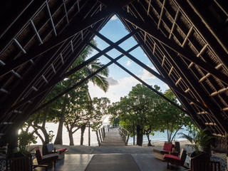 Beautiful Traditional A Frame Building Looking out to Landscape of Beach and Sea Ocean from Inside at Sunset on Tropical South Pacific Island of Fiji