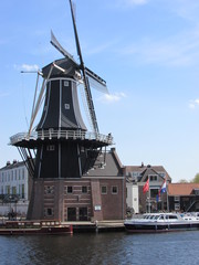Fototapeta na wymiar Dutch windmill on the riverside, Haarlem