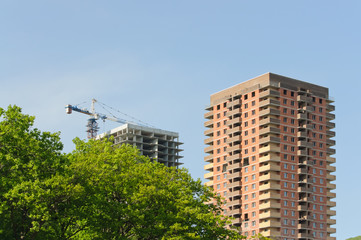 Crane on a construction site at home against a blue sky