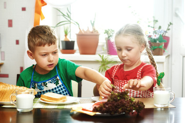 Cheerful children at Breakfast . Brother and sister with sandwiches