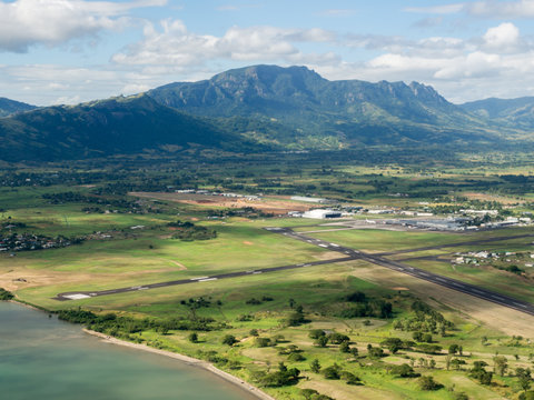 Aerial Landscape View Of The Mountain Tropical Coastline Beach Of Nadi Airport Runway, Fiji In The South Pacific