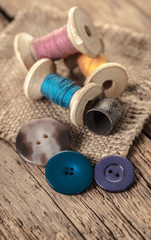 spool of threads and buttons