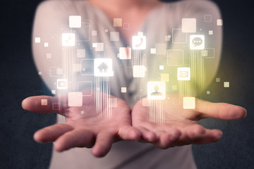 Blue social application icons in the hands of young casual businesswoman