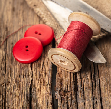 red thread with buttons and scissors