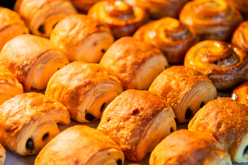 Croissants in a bakery shop. freshly baked croissants on texture background.