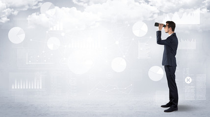 Businessman looking forward with binoculars cloudy background and graphs, charts around
