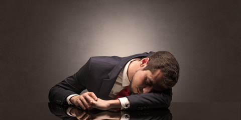 Young businessman fell asleep at his workplace with copy space