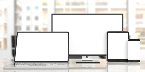 Set of realistic blank monitors. Computer monitor, laptop, tablet and smartphone on wooden desk, blur office background. 3d illustration