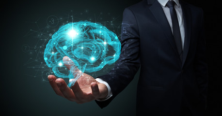 Businessman holding human brain on his hand with logistics symbols around