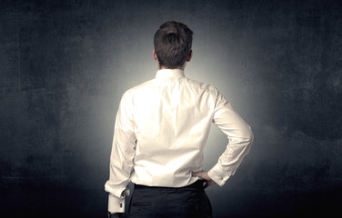Young businessman standing and thinking alone