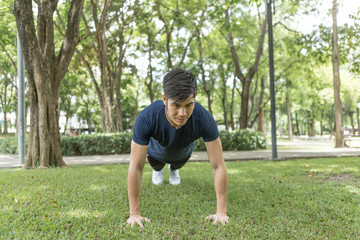A young sportsman getting ready for athletic and fitness training outdoors. Healthy lifestyle concept with sunrise early morning.