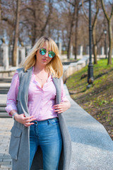 A woman of plus size, American or European appearance walks in the city enjoying life. A young lady with excess weight, xl size at the center of the city. Natural beauty  