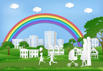 Happy family having fun in the park and rainbow on blue sky, Paper art background