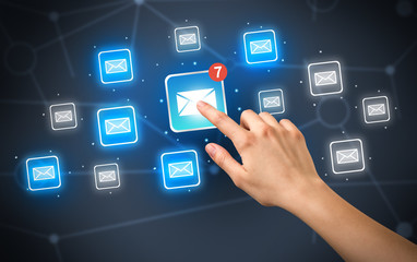 Female hand touching unread mail icon with more envelope icons around it 
