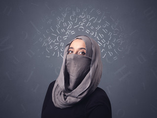Young muslim woman wearing niqab with white alphabet letters above her head