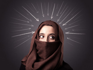 Young muslim woman wearing niqab with white arrows pointing to her head 