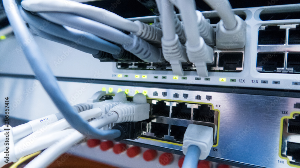Poster network cables connected to switch - closeup of data center hardware.