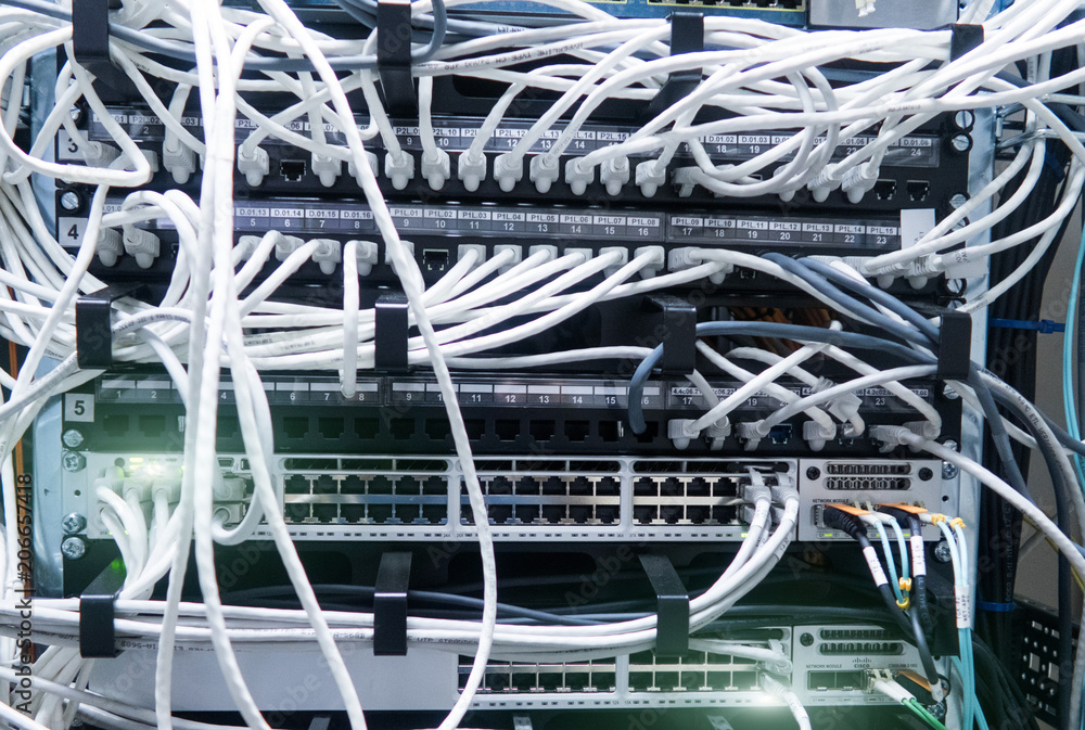 Poster network cables connected to switch - closeup of data center hardware.