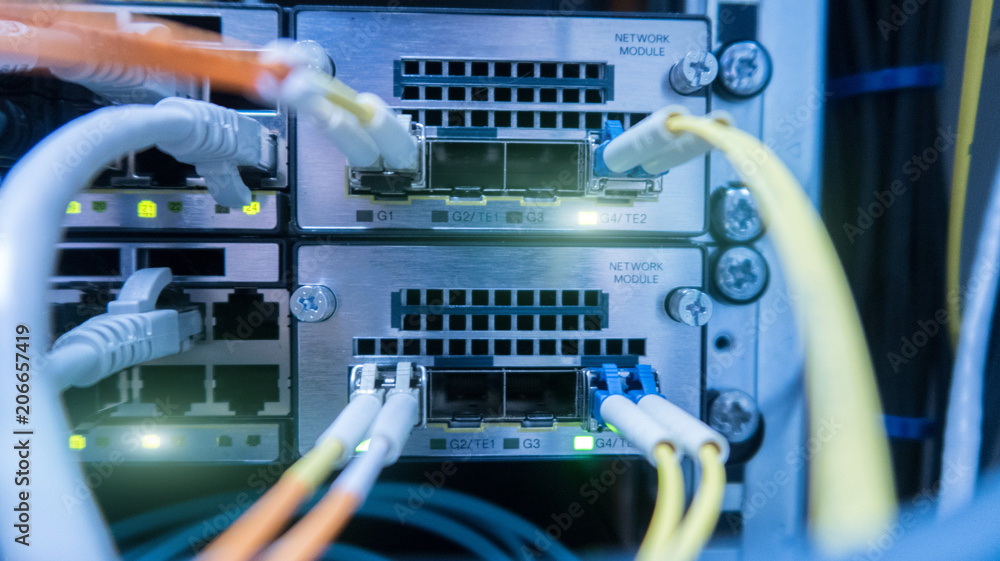 Poster network cables connected to switch - closeup of data center hardware.