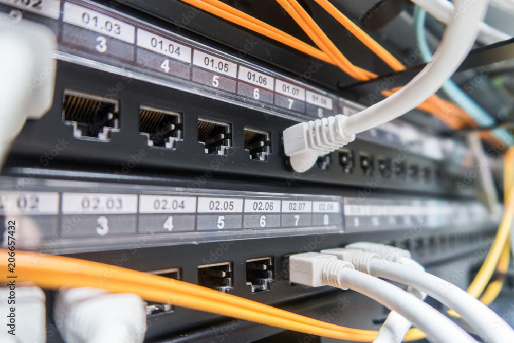 Poster network cables connected to switch - closeup of data center hardware.
