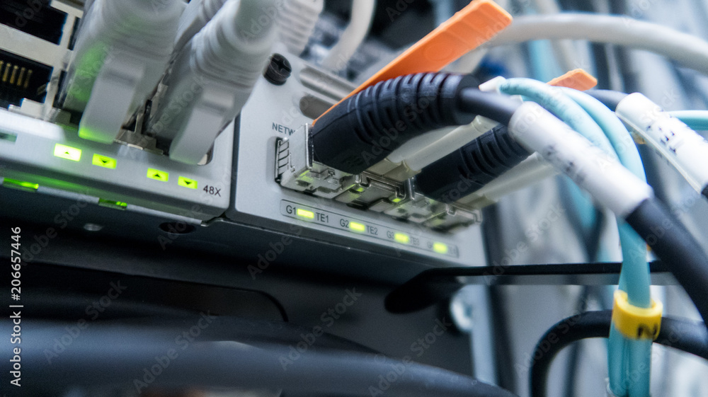 Poster network cables connected to switch - closeup of data center hardware.
