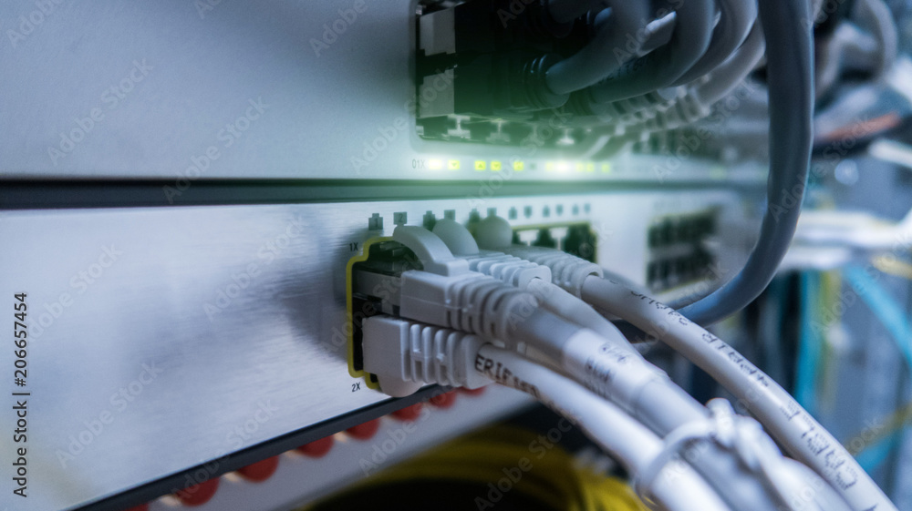 Poster network cables connected to switch - closeup of data center hardware.