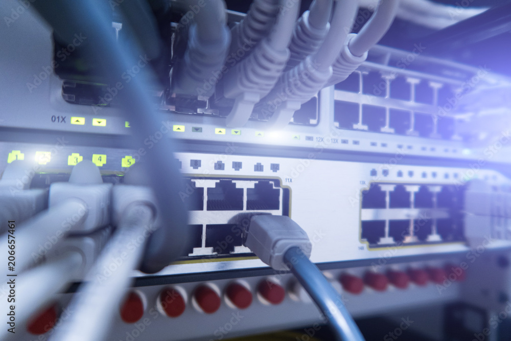 Poster network cables connected to switch - closeup of data center hardware.