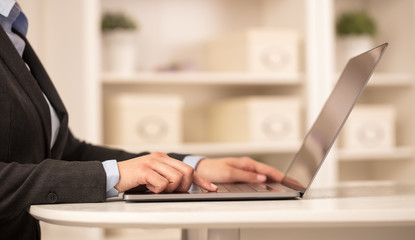 Business woman in homey environment using laptop with cloud technology concept
