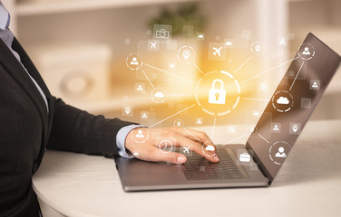 Business woman below chest working on laptop in a cozy homey environment with secured connection concept
