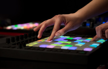 Obraz premium Dj hand remixing music on midi controller 