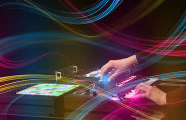 Hand mixing music on midi controller with colorful vibe concept
