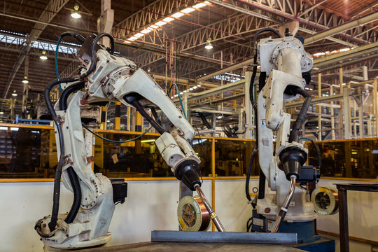 Robots welding team in the automotive parts industry are in teaching mode